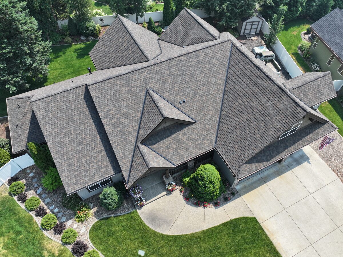 Aerial view of a North Idaho home roofed in CertainTeed Landmark TL shingles in Shenandoah, a warm brown blend across a complex hip roof