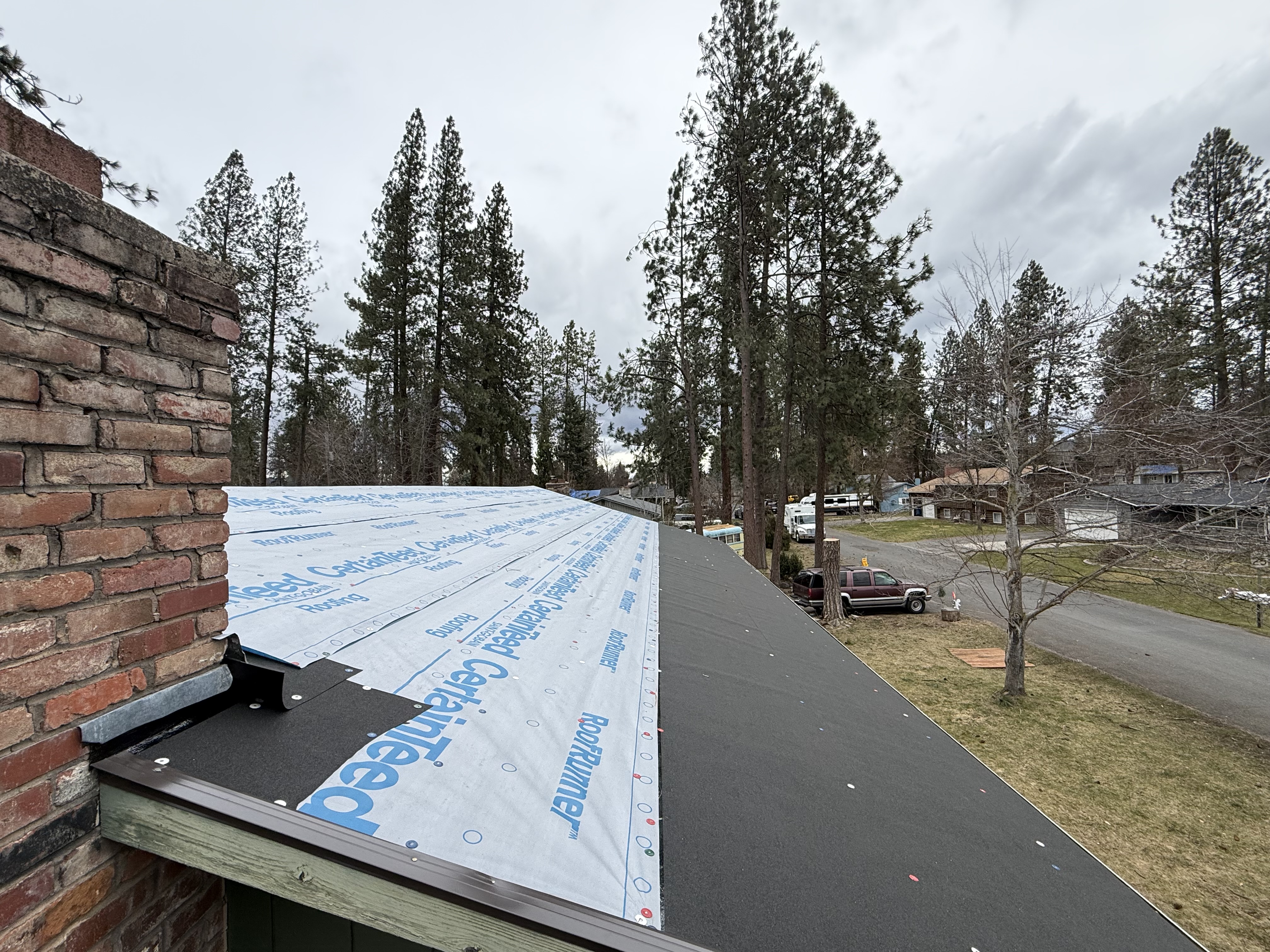 Close-up of a North Idaho roof showing improper fastener use that voids manufacturer warranty