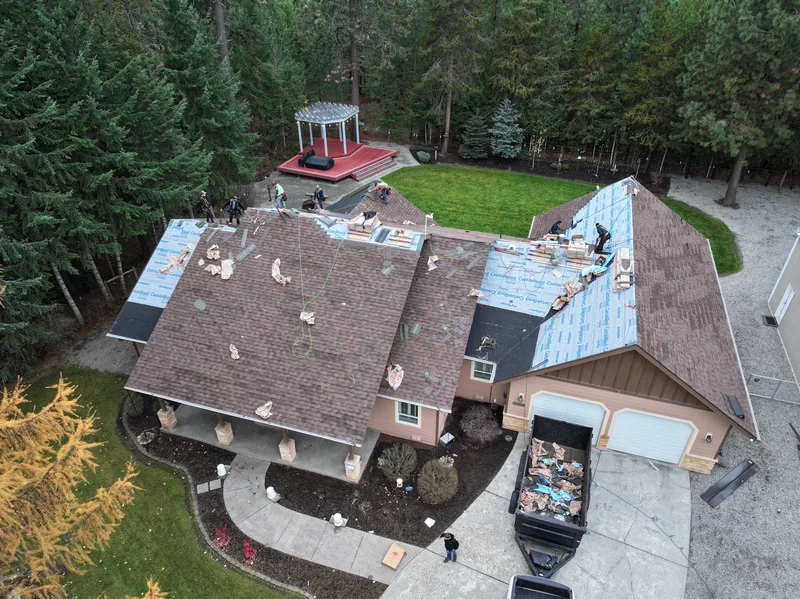 Aerial view of a North Idaho home with an aging roof in need of replacement