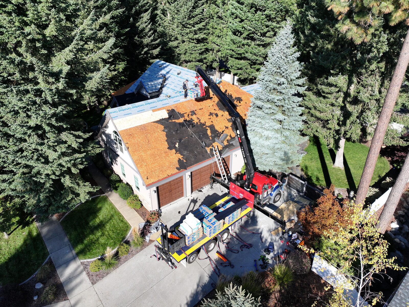 North Idaho roof replacement in progress with crew installing new asphalt shingles