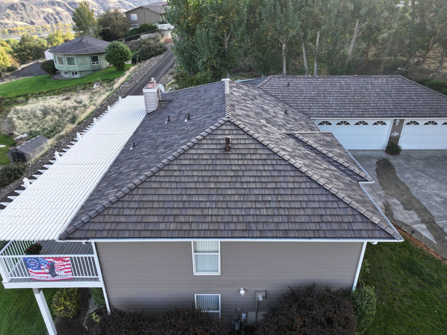 After: hip end of the new Aged Cedar Brava roof over the deck