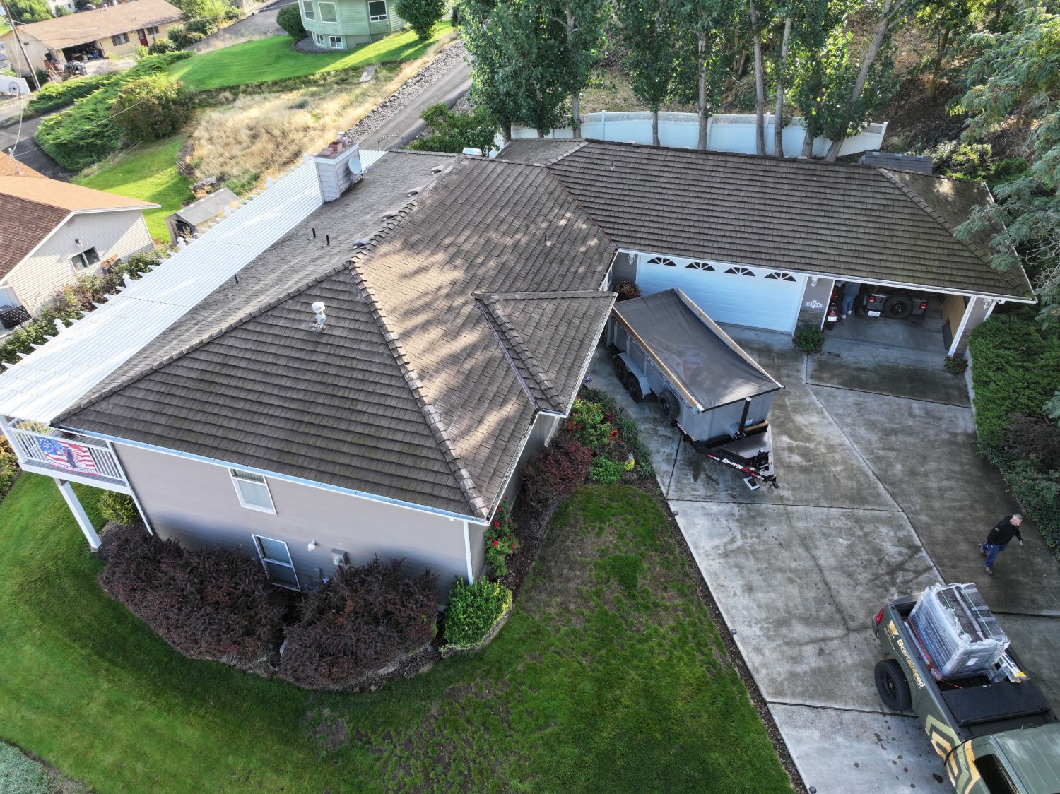 Before: aerial view of the faded, stained synthetic shake roof