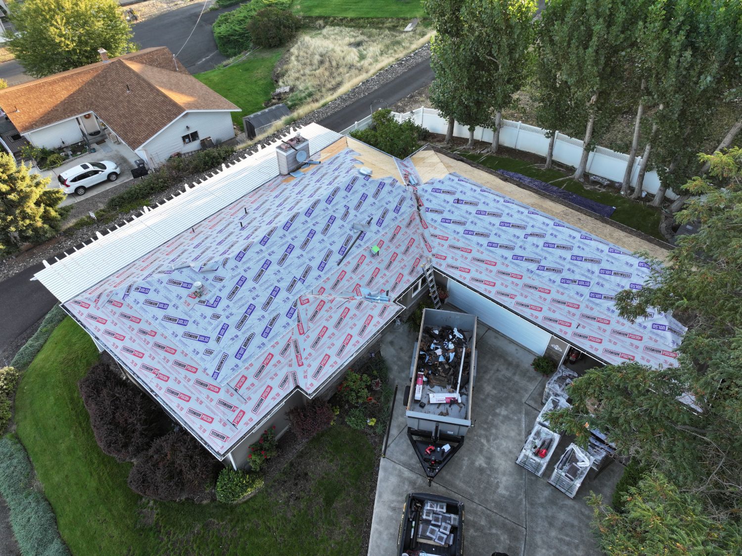 During: old roof torn off and new synthetic underlayment installed across every slope