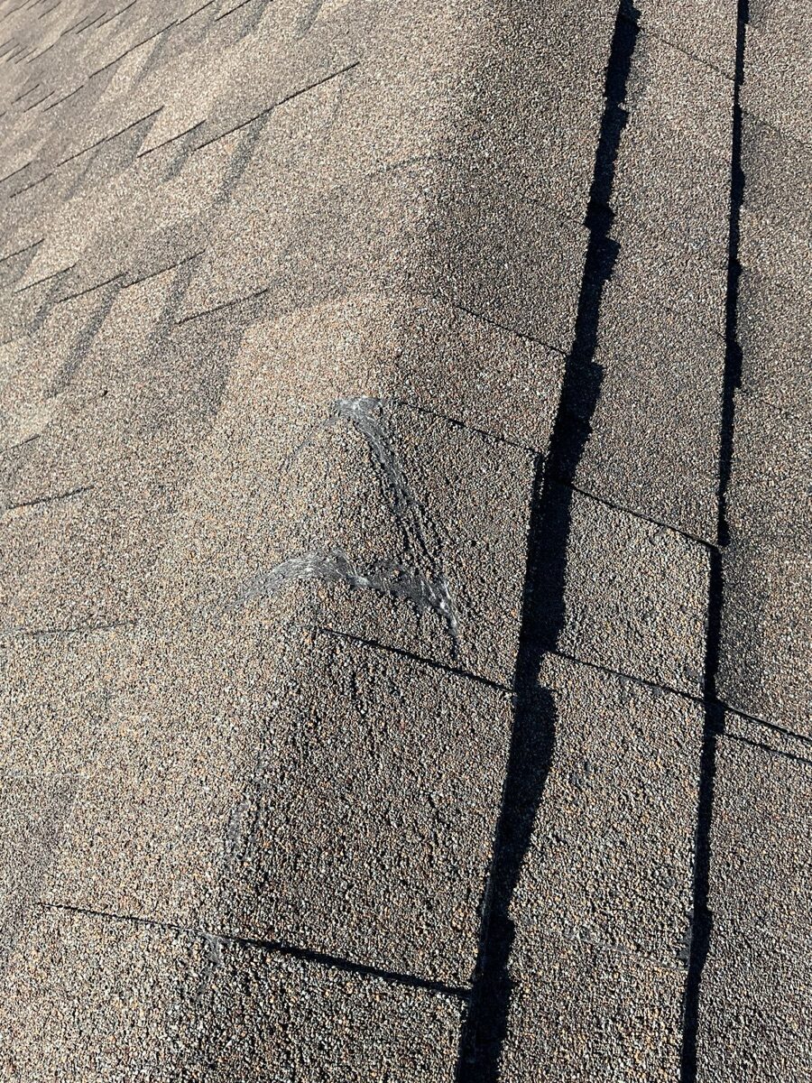 Before: worn shingles with exposed fiberglass mat and granule loss