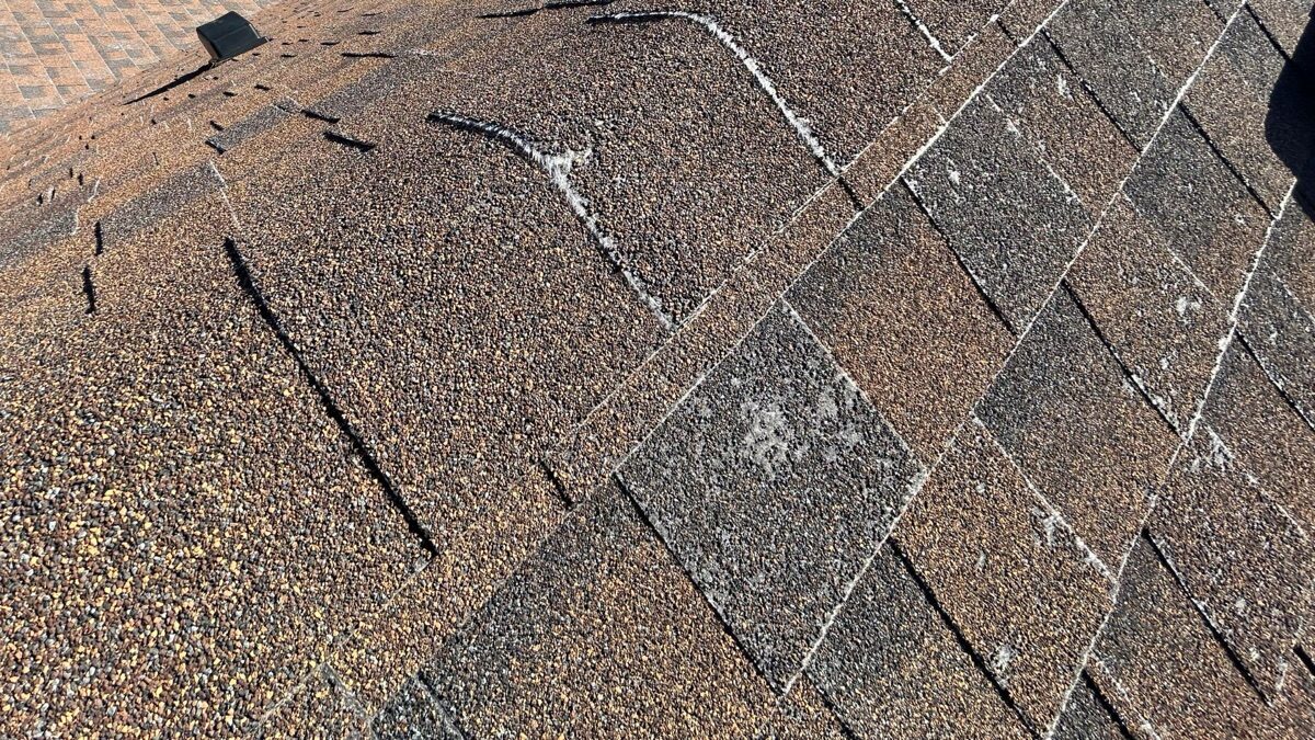 Heavy granule loss and curling shingle tabs before tear-off
