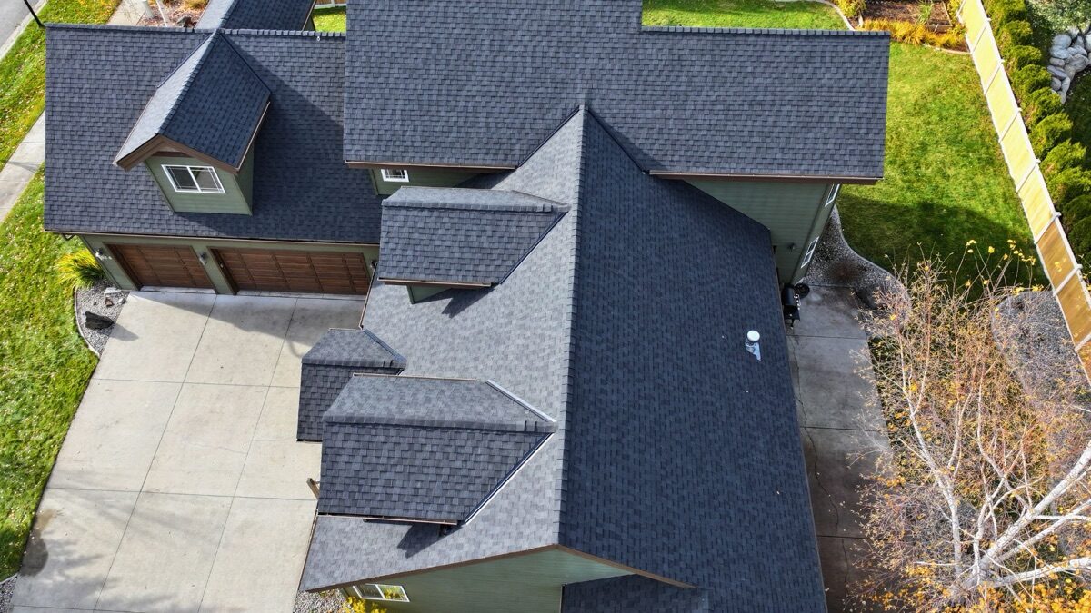 Aerial angled view of completed roof showing dormers and multiple roof planes