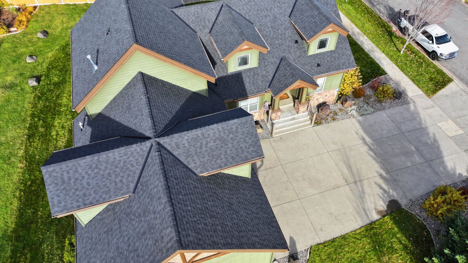 After: aerial view of completed Moire Black Climate Flex roof with dormers