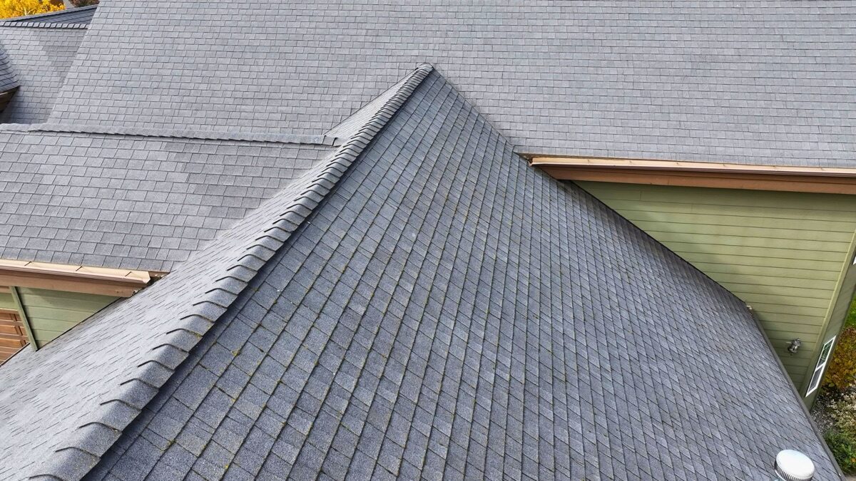 Close-up aerial of worn shingles at the ridge line