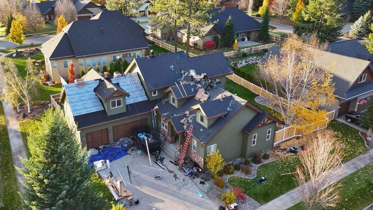 Aerial view during tear-off — partial underlayment with crew working