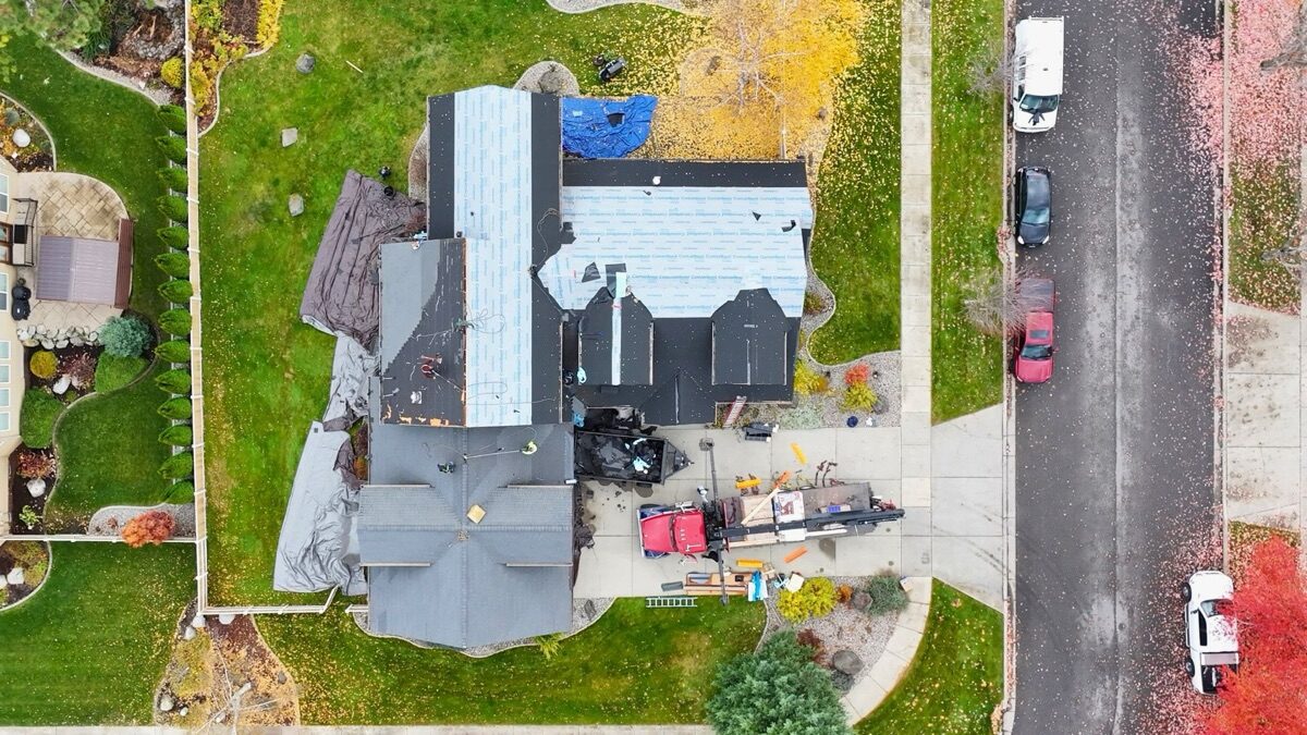 Top-down aerial during tear-off — old material being removed