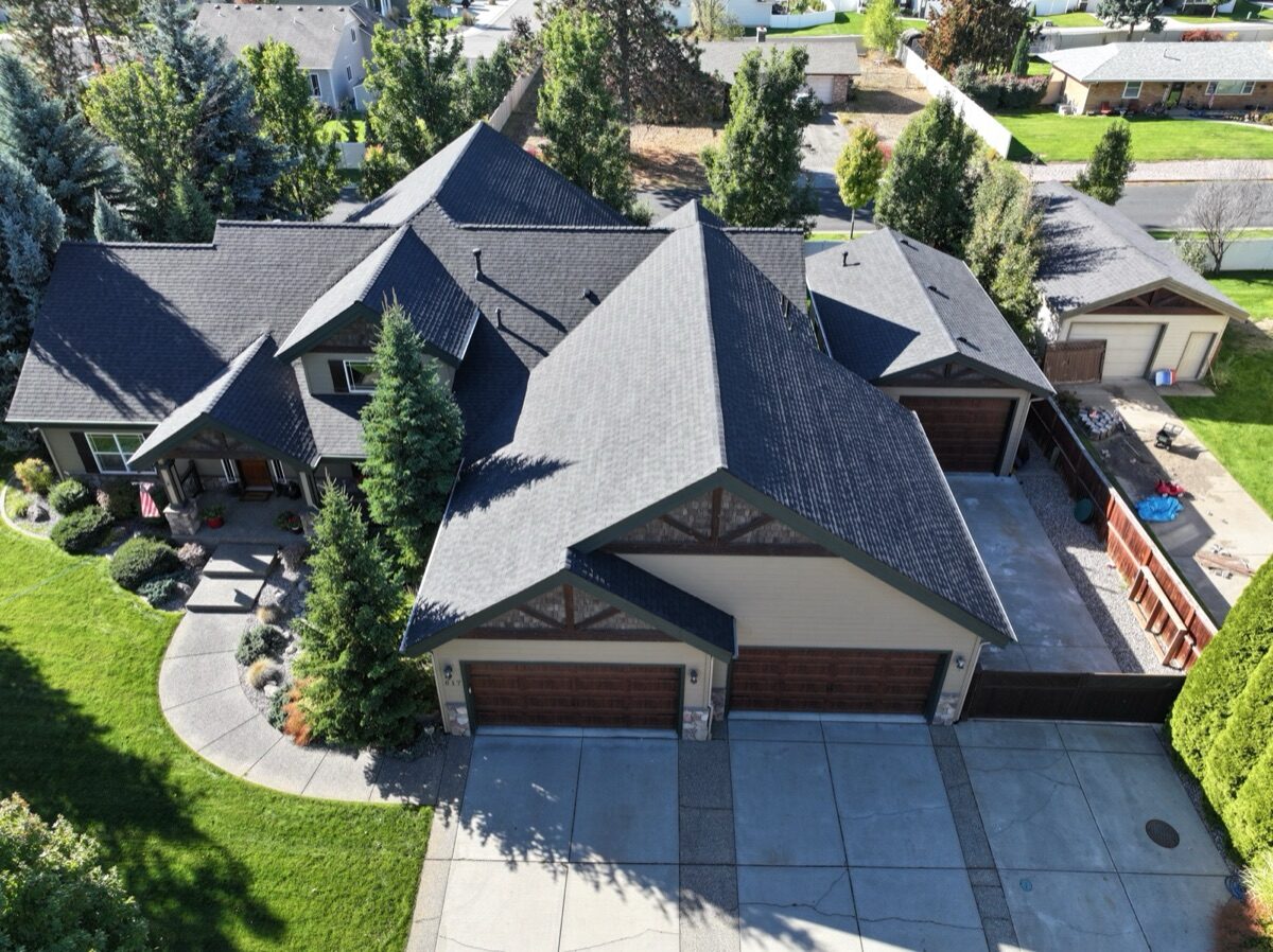 Completed roof — front aerial view showing garage and driveway