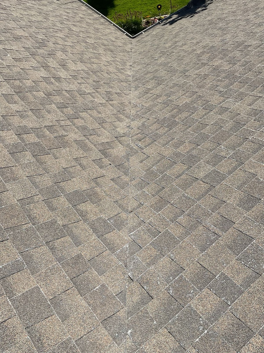 Aerial top-down view of old roof at ridge line showing granule wear pattern